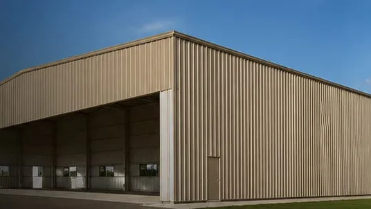 Illustration, not a photo of a real project: a beige steel-clad building on a gravel and asphalt apron, its long side open on deep equipment bays.